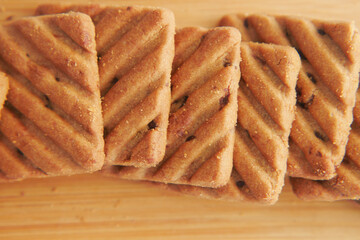 close up of sweet cookies on wooden table 