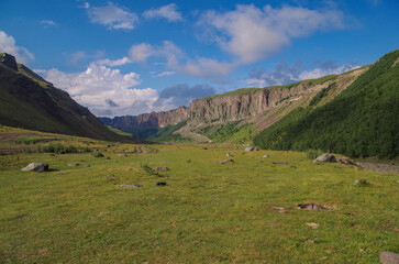 Beautiful evening view of meadow and mountain valley. View from camp on river Malka. Nature and travel. Russia, Caucasus, Kabardino-Balkaria