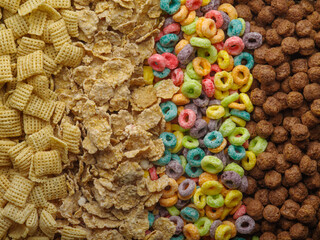 Assorted whole grain breakfasts - crispy pads, cereals, fruity corn rings and chocolate balls. Healthy vegetarian and baby food. Banner, advertising.