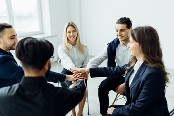 Coworkers giving high-five in meeting room at creative modern office