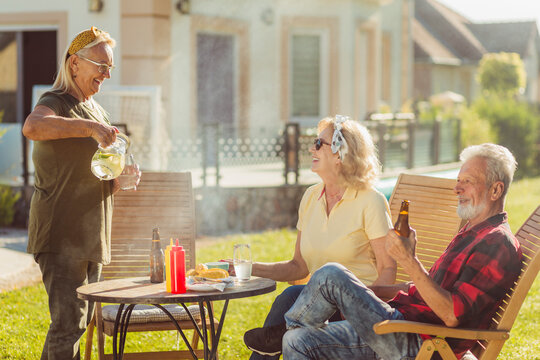 Elderly people having an outdoor lunch - Powered by Adobe