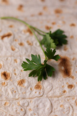 Lavash rolled on a wooden background, thin traditional oriental bread, Armenian flatbread macro