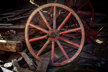 Fototapeta na wymiar ancient red wooden wheel with spokes