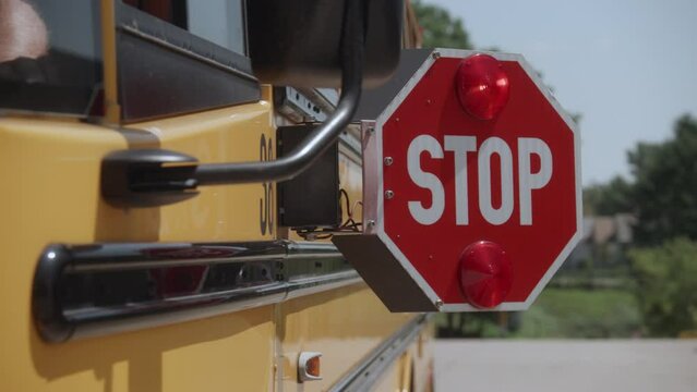 dolly shot of School bus stop sign opening