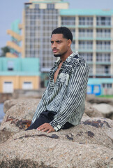 Portrait of cool young african man dancing at the beach on summer day