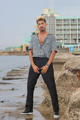 Portrait of cool young african man dancing at the beach on summer day