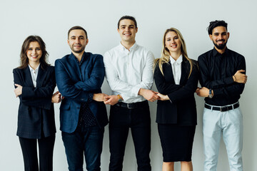 Group of business workers standing together shakinghands at the office