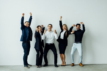 Team of businesspeople cheering win gesture with clenched fist in the office