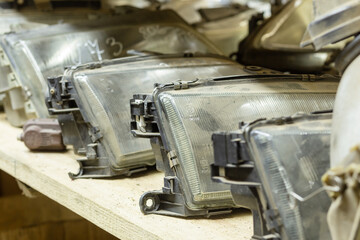 Used headlamp components for sale on the store shelf.