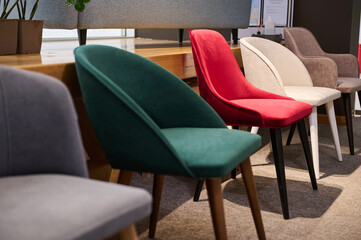 Chairs in salon of furniture. Showroom, exhibition hall of modern soft furniture, upholstered furniture