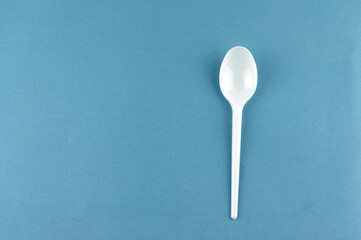 plastic spoon on a blue background