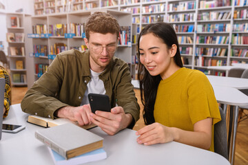 University students are studying in a library together as teamwork for preparation