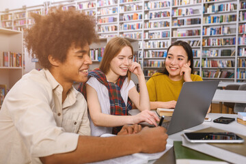 University students are studying in a library together as teamwork for preparation