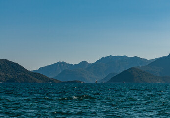 Yacht sailing on the sea among the mountains