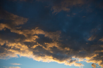 Thick clouds at sunset against a blue sky