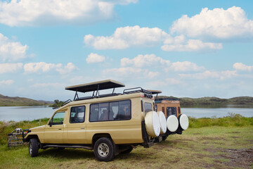 Arusha, Tanzania, 31 january 2022.  two safari jeeps 4x4 with open roofs stand near the lake in the African park Tarangire