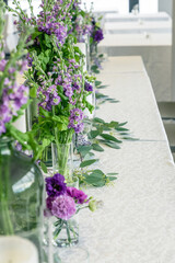 Purple and violet wedding flower arrangements, made out of carnations lisianthus and matthiola flowers. 