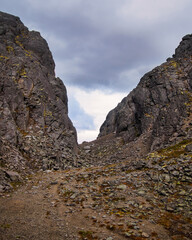 Gray lifeless rocky pass in the mountains. Khibiny, Russia.