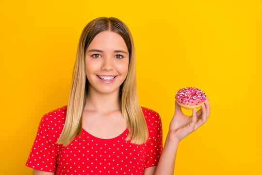 Photo of young pretty girl hold delicious cookies diet calories isolated over yellow color background