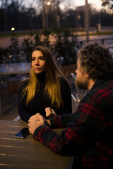 couple comforting each other in a cafe in the evening