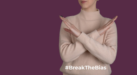 Break the bias symbol of woman's international day. Crossed hands. Woman arms crossed to show...