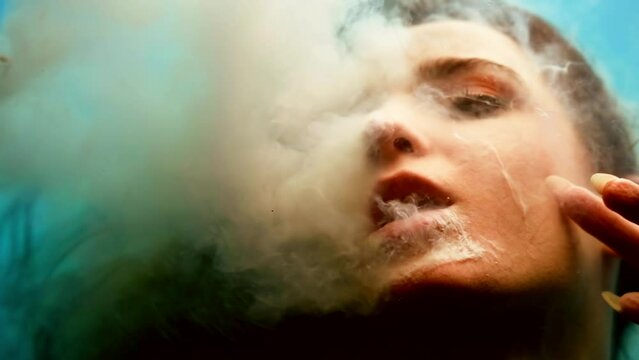 close-up portrait of a woman under water in a trance state immersed as in space weightlessness white liquid flows out of her mouth