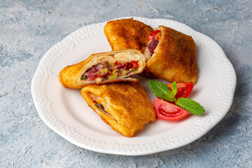 Turkish Pacanga Boregi with pastirma (pastrami) and cheddar (melted) cheese. - Pastirmali Borek
