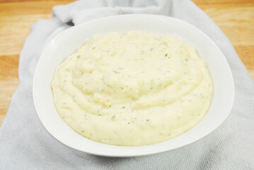 A Bowl of Creamy Buttery Mashed Potatoes with Herbs
