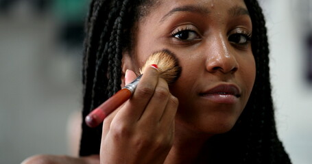 African black teen applying make-up