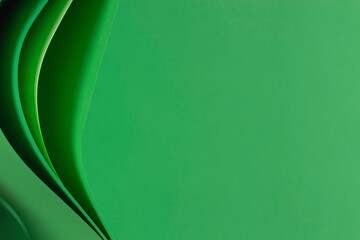Abstract monochrome paper geometry composition background. Curved lines and shapes on green background