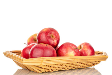Fototapeta na wymiar A few sweet organic, red apples in a plate of straw, macro, isolated on a white background.