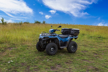 ATV or quad bike in the field outside the city. Background with copy space for text
