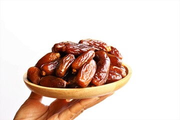 hand holding wooden plate of  dried date fruits photo isolate on white background front view copy space 