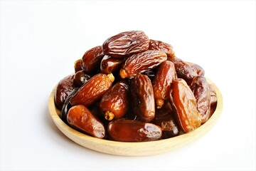 dried dates in a wooden plate photo isolate on white background top view copy space 