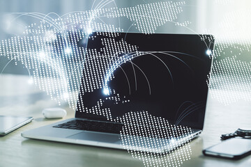 Double exposure of abstract digital world map with connections on laptop background, research and strategy concept