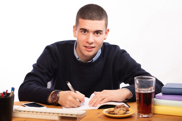 young men writing in a book