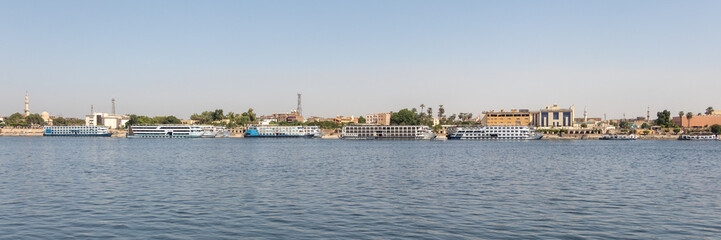 Fototapeta na wymiar Luxor, Egypt - September 21, 2021: Cruise ships on Nile river, River cruising is a comfortable, luxury hotel-style way, Luxor, Egypt