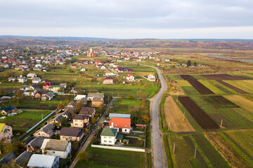 Fototapeta na wymiar Aerial view of home roofs in residential rural neighborhood area.