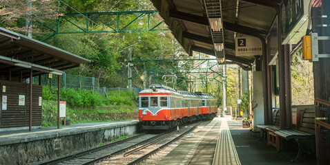 Hakone, Japan, April 2018. The Hakone Tozan train arriving at station in Hakone, Japan. Red...