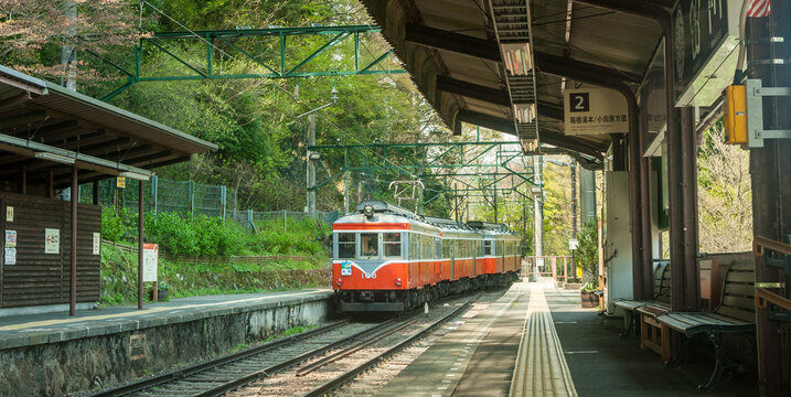 Hakone, Japan, April 2018. The Hakone Tozan train arriving at station in Hakone, Japan. Red nostalgic train at beautiful Hakone station, no people.