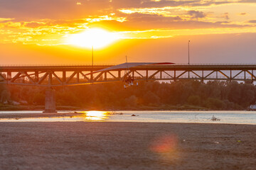 Fototapeta na wymiar A motor glider at sunset over the bridge
