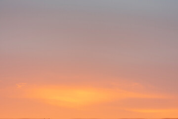 background or texture of the sky at sunset with a gradient of colors from blue to orange