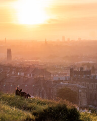a couple watching the sunset in Edinburgh from Calton Hill