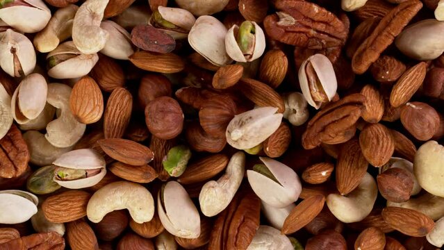 Super slow motion of moving mix nuts. Filmed on high speed cinematic camera at 1000 fps.