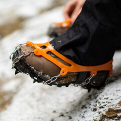 Close up of snow shoes and shoe spikes in winter. 