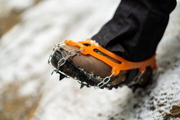 Close up of snow shoes and shoe spikes in winter. 
