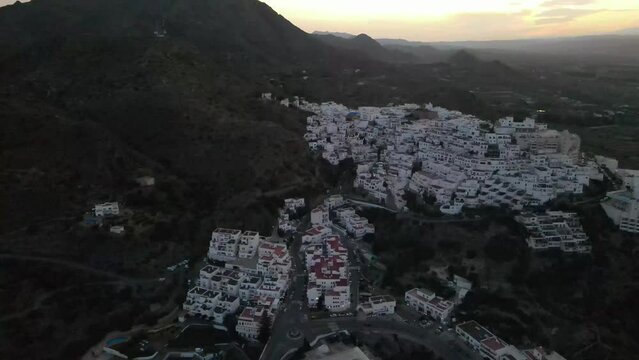 Dron shot Espania Spain church open shot sun afternoon sky buildings smog water lake paning left moutan sea covid trees tree front green blue back cars rush hour road covid empty sun sunset white hous