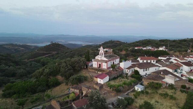 Dron shot Espania Spain church open shot sun afternoon sky buildings smog water lake paning left moutan sea covid trees tree front green blue back cars rush hour road covid empty sun sunset natura.mp4