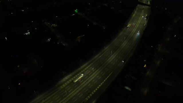 Dron shot UK england open shot night over night sky buildings London smog mist dark church paning left covid trees tree front green bus back cars rush hour dark highway vol.2.mp4