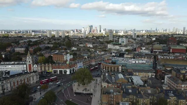 Dron shot UK england open shot sun afternoon sky buildings London smog mist dark church paning left covid trees tree front green bus back cars rush hour.mp4